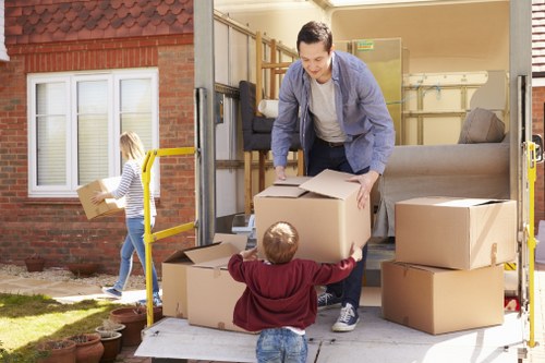 Packed household boxes and furniture ready for transport in Highbury