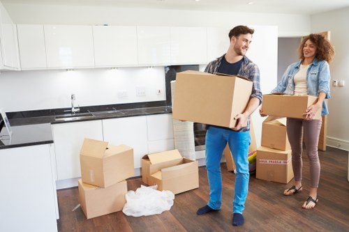 Mover handling a sofa carefully on a narrow Highbury staircase