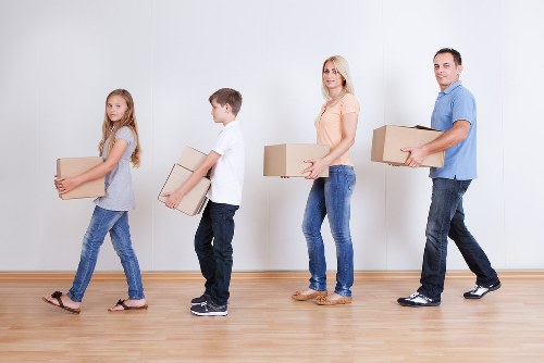 Removal staff handling desks and office equipment in Highbury